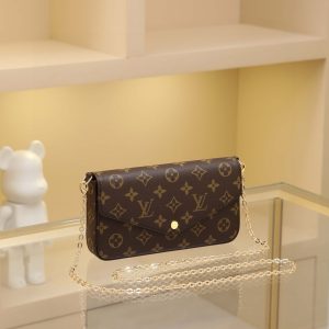 Alternative view of The Felicie handbag is an elegant and compact accessory featuring two detachable pockets, making it a stylish choice for carrying and organizing your daily essentials. More than just a wallet, it transforms into a charming clutch or small handbag when the gold chain is removed.- 1 flat inner pocket - Two detachable components: a zippered pocket with leather pull tab and a flat flap pouch with 8 credit card slots - Detachable shiny gold chain - Button closure - Calfskin trim - Fabric lining - Shiny gold-tone hardware Dimensions: 21*11*2 cm